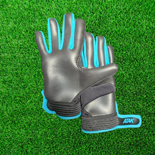 Black and blue ATAK air gloves on a green grass background