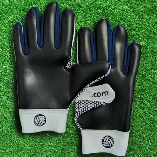 White and navy Fetch V1 gloves on a green grass background