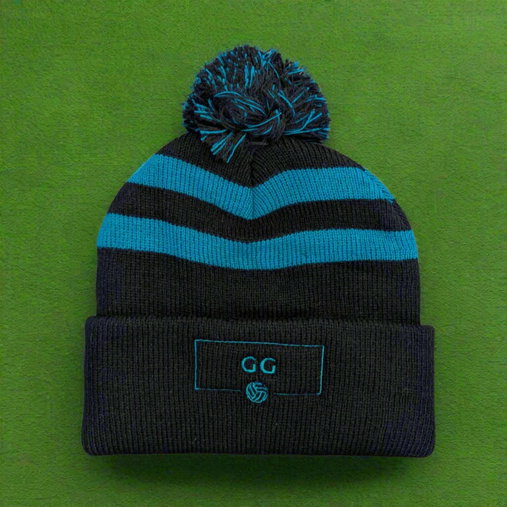 A black and teal striped bobble hat with a large pom-pom on top, featuring the 'GG' logo on the cuff.