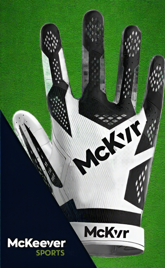 White and black McKeever gloves on a green grass background