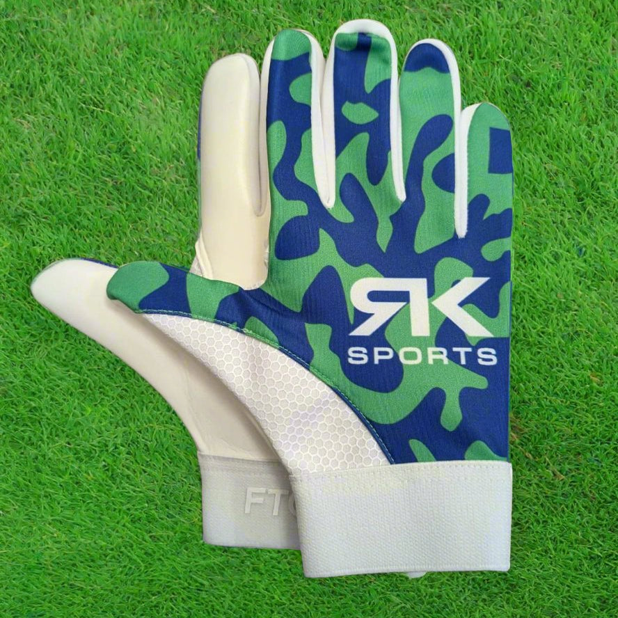 Blue and green RK sports gloves on a green grass background