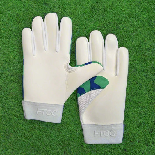 Blue and green RK sports gloves on a green grass background