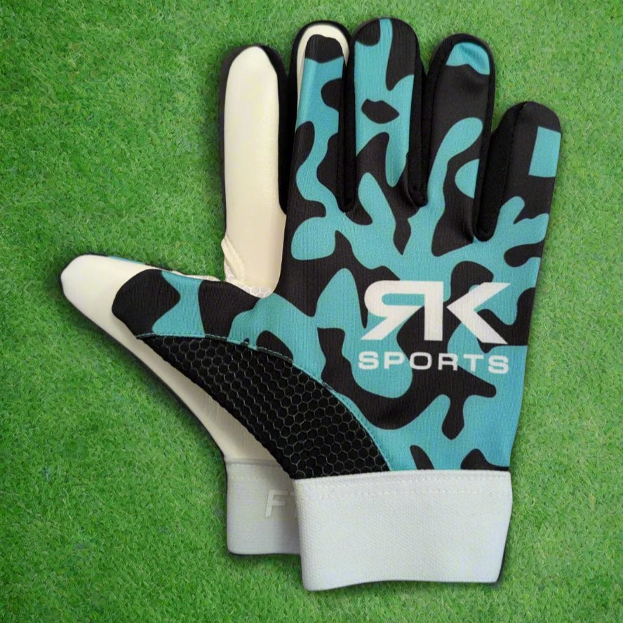 Teal and black RK sports gloves on a green grass background