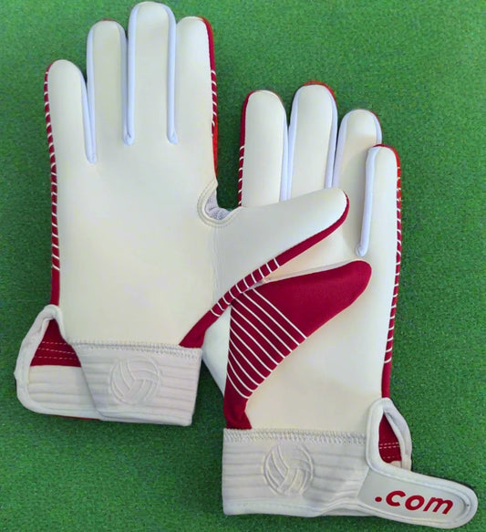 Red and white Straight edge strapped gloves on a green grass background