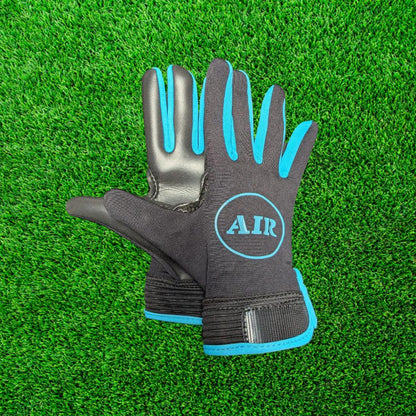 Black and blue ATAK air gloves on a green grass background