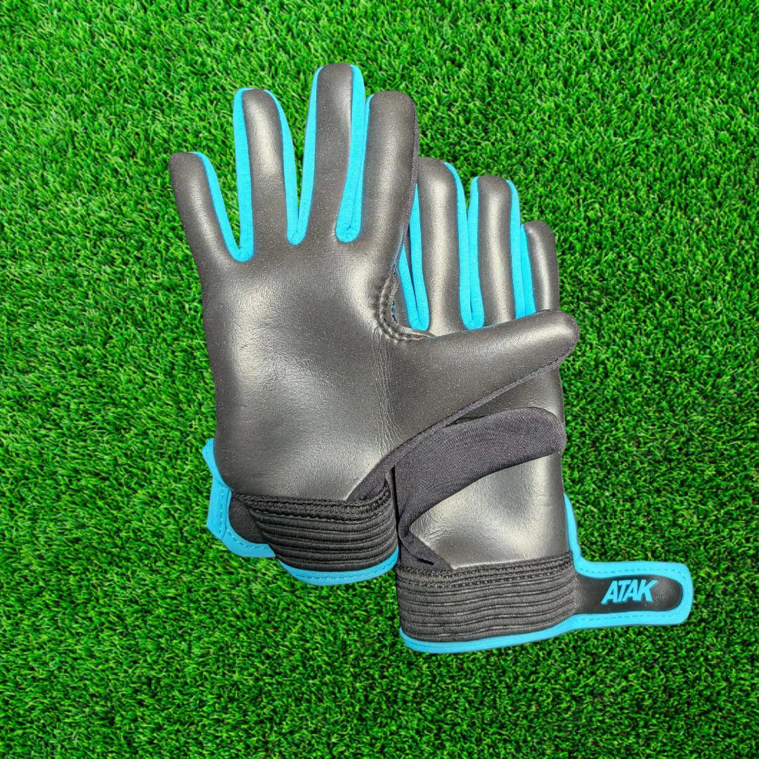 Black and blue ATAK air gloves on a green grass background