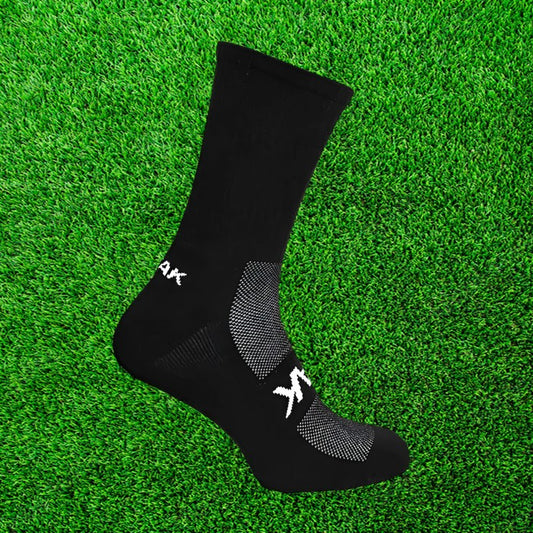 Black ATAK sock on a green grass background