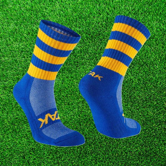 Blue and Yellow ATAK sock on a green grass background