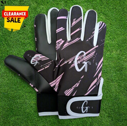 Black and pink Gunning's gloves on a green grass background with a clearance sticker
