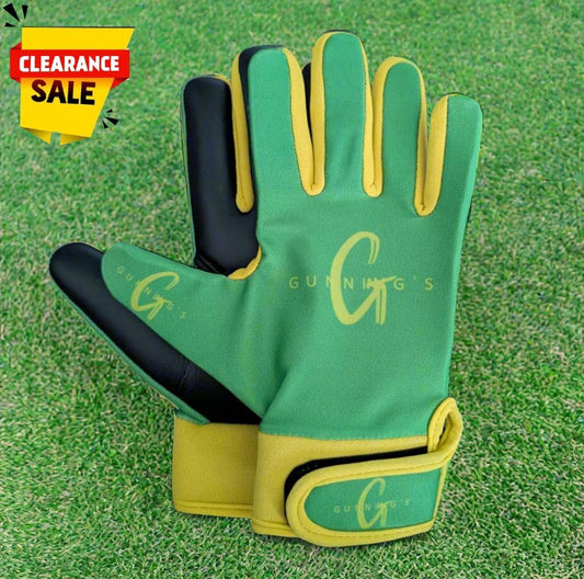 Green and yellow Gunning's gloves on a green grass background with a clearance sticker