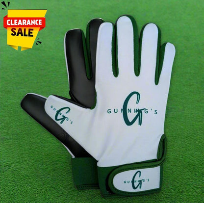 White and green Gunning's gloves on a green grass background with a clearance sticker
