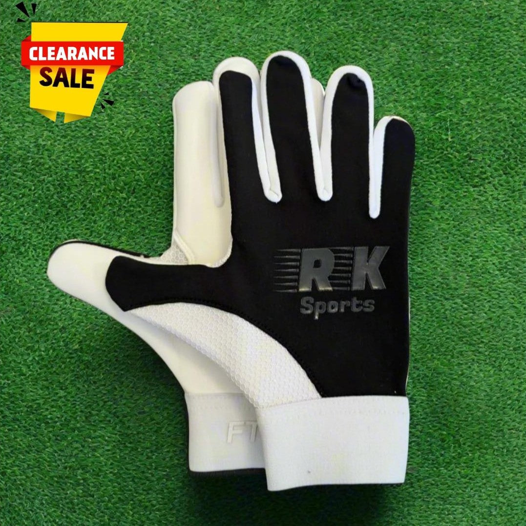 Black RK sports gloves on a green grass background with a clearance sticker